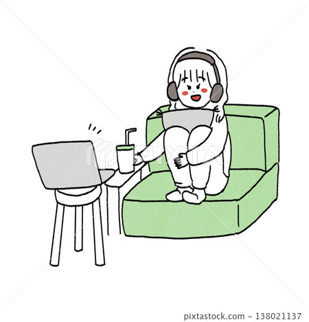 Girl sitting on sofa watching movie with headphones 138021137