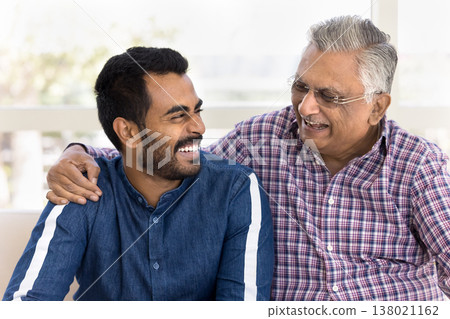 Laughing Indian man spend priceless time with older grandfather Laughing Indian man spend priceless time with older grandfather 138021162