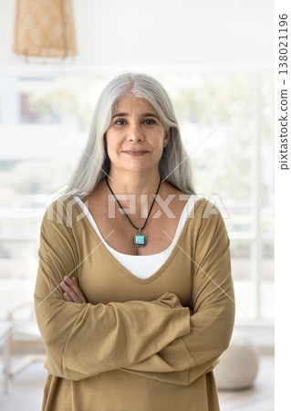 Older woman looking at camera, standing alone indoor Older woman looking at camera, standing alone indoor 138021196