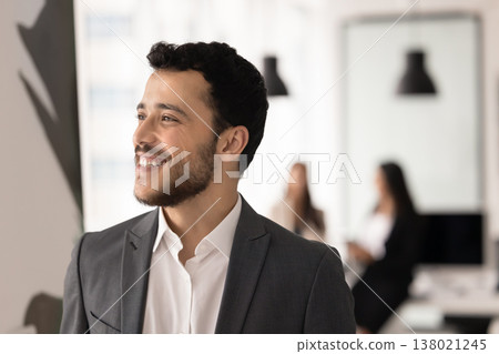 Smiling Arabic man dressed in formal suit looking into distance Smiling Arabic man dressed in formal suit looking into distance 138021245