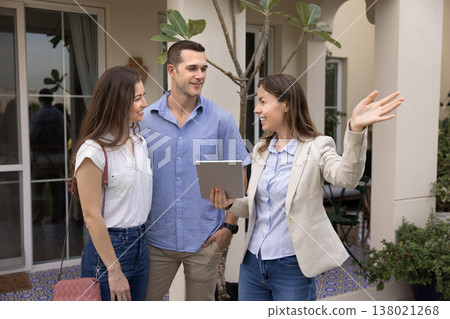 Real estate agent showing residential property to couple 138021268