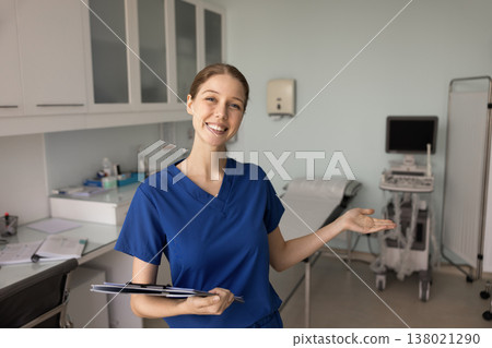 Sonographer inviting client in modern clinic room with ultrasound equipment Sonographer inviting client in modern clinic room with ultrasound equipment 138021290