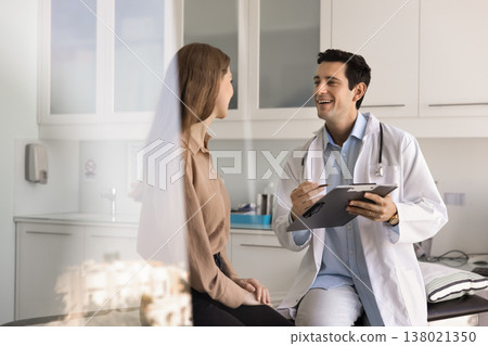 Doctor asking about health condition, symptoms or concerns to patient 138021350