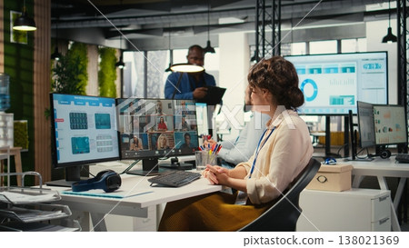 Employees sharing ideas on a web video conference call at the workstation, discussing about project briefing with charts and reports. Business associates attending online meeting event. Employees sharing ideas on a web video conference call at the workstation, discussing about project briefing with charts and reports. Business associates attending online meeting event. 138021369