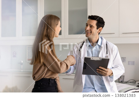 Woman shaking hands with doctor, finalizing consultation in clinic office 138021383