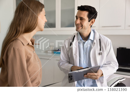 Doctor consulting female patient in medical office 138021390
