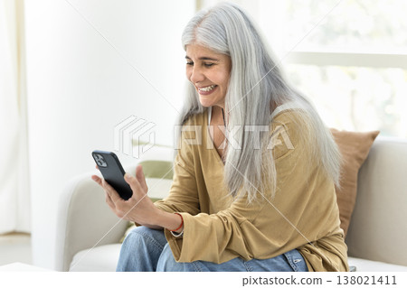 Middle aged Venezuelan woman using modern cellphone Middle aged Venezuelan woman using modern cellphone 138021411