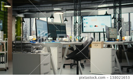 Empty business workplace filled with desks and dual monitors, modern and digital equipment to ensure multinational company success and efficiency. Office used for forecasting and report writing. Empty business workplace filled with desks and dual monitors, modern and digital equipment to ensure multinational company success and efficiency. Office used for forecasting and report writing. 138021653