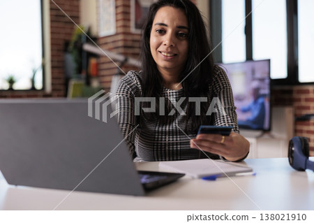 Indian person doing online shopping with credit card, making online purchase on retail store website. Doing electronic payment transaction on sale discount, remote work on laptop at home. Indian person doing online shopping with credit card, making online purchase on retail store website. Doing electronic payment transaction on sale discount, remote work on laptop at home. 138021910