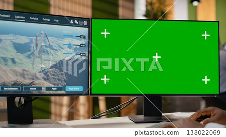 Technician working on futuristic wind turbine concept on isolated screen PC designed for clean energy output. Man in office uses chroma key computer to research cutting edge VAWT innovation, camera B 138022069