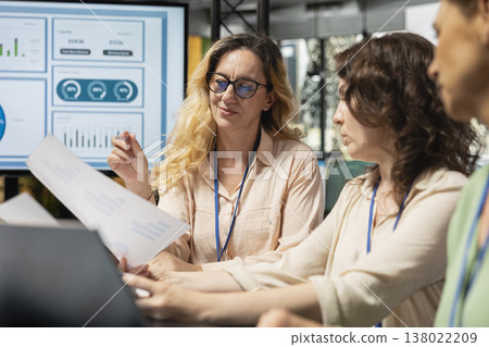 Ambitious career driven multiethnic professionals collaborate over analytics and planning documents, leading a corporate project with rich innovative ideas and a powerful mindset. 138022209