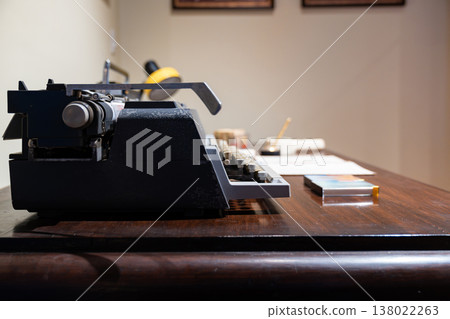 Vintage office desk with typewriter, rotary telephone, and analog equipment representing classic workspace environment. Vintage office desk with typewriter, rotary telephone, and analog equipment representing classic workspace environment. 138022263