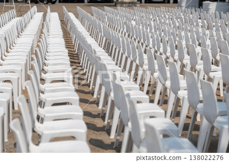 Large scale seating setup with many chairs prepared for an audience in a big event or conference environment. 138022276