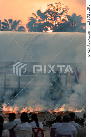 Strong flames and intense heat used for a metal casting process in an outdoor environment representing traditional craftsmanship and industrial activity. Strong flames and intense heat used for a metal casting process in an outdoor environment representing traditional craftsmanship and industrial activity. 138022299