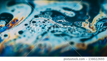 Stain oil bubbles. Holographic ink. Defocused blue orange yellow color psychedelic flow gasoline round fuel drop on abstract background. Stain oil bubbles. Holographic ink. Defocused blue orange yellow color psychedelic flow gasoline round fuel drop on abstract background. 138022693