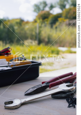 Carpentry and repair tools.resting on wood texture ,with a blurred outdoor background. Home improvement concept Carpentry and repair tools.resting on wood texture ,with a blurred outdoor background. Home improvement concept 138023024
