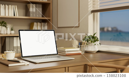 White screen laptop with coffee on wooden table aside bookshelf and window with sea view in office. 138023108