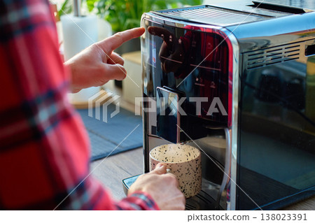 Man making coffee with espresso machine at home 138023391