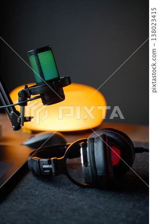Podcast studio setup with microphone, headphones and laptop on desk Podcast studio setup with microphone, headphones and laptop on desk 138023415