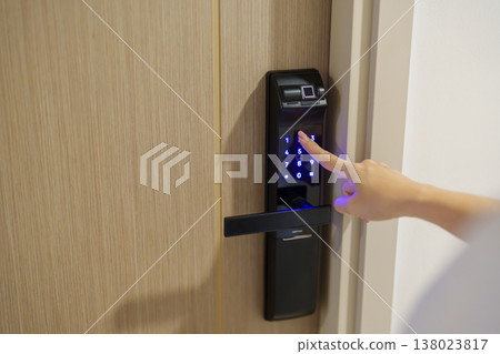 Hand press PIN number for smart digital door lock while open or close the door at home or apartment. NFC Technology, Fingerprint scan, keycard, smartphone and contactless lifestyle concepts 138023817