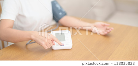 woman checking Blood pressure by Blood pressure monitor with Cuff. Systolic, SYS, Diastolic, DIA, Pulse, Hypertension, Hypotension, Heart rate, Cardiovascular Disease and May World hypertension day woman checking Blood pressure by Blood pressure monitor with Cuff. Systolic, SYS, Diastolic, DIA, Pulse, Hypertension, Hypotension, Heart rate, Cardiovascular Disease and May World hypertension day 138023828