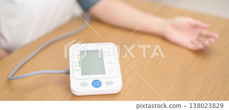 woman checking Blood pressure by Blood pressure monitor with Cuff. Systolic, SYS, Diastolic, DIA, Pulse, Hypertension, Hypotension, Heart rate, Cardiovascular Disease and May World hypertension day woman checking Blood pressure by Blood pressure monitor with Cuff. Systolic, SYS, Diastolic, DIA, Pulse, Hypertension, Hypotension, Heart rate, Cardiovascular Disease and May World hypertension day 138023829