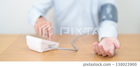 Man checking Blood pressure by Blood pressure monitor with Cuff. Systolic, SYS, Diastolic, DIA, Pulse, Hypertension, Hypotension, Heart rate, Cardiovascular Disease and May World hypertension day 138023900