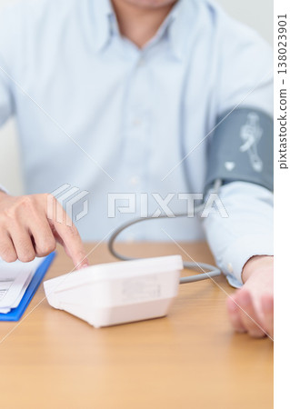 Man checking Blood pressure by Blood pressure monitor with Cuff. Systolic, SYS, Diastolic, DIA, Pulse, Hypertension, Hypotension, Heart rate, Cardiovascular Disease and May World hypertension day Man checking Blood pressure by Blood pressure monitor with Cuff. Systolic, SYS, Diastolic, DIA, Pulse, Hypertension, Hypotension, Heart rate, Cardiovascular Disease and May World hypertension day 138023901