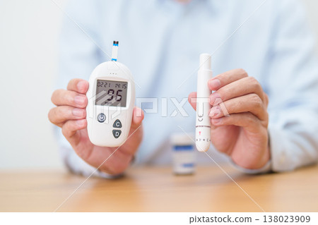 Hand checking Diabetes or Blood glucose self testing by digital blood glucose meter with lancet pen. high blood sugar level, World Diabetes Day, Glycemia, Hypoglycemia, Hyperglycemia and insulin Hand checking Diabetes or Blood glucose self testing by digital blood glucose meter with lancet pen. high blood sugar level, World Diabetes Day, Glycemia, Hypoglycemia, Hyperglycemia and insulin 138023909