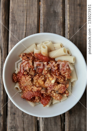 Brown rice pasta with plenty of minced meat and homemade tomato sauce. Brown rice pasta with plenty of minced meat and homemade tomato sauce. 138023931