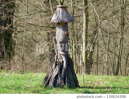 Handmade Wooden Insect Hotel with Thatched Roof in a Spring Garden. Handmade Wooden Insect Hotel with Thatched Roof in a Spring Garden. 138024306