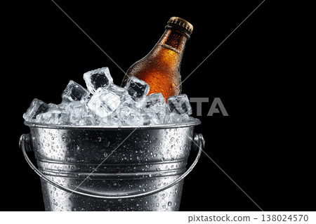 Cold brown bottle in metal bucket filled with ice cubes on black background with clipping path, concept of refreshment and cooling Cold brown bottle in metal bucket filled with ice cubes on black background with clipping path, concept of refreshment and cooling 138024570