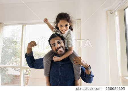 Kid and dad striking together playful strongman pose Kid and dad striking together playful strongman pose 138024605