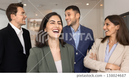 Colleagues laughing, exchanging jokes, representing camaraderie, positive work relations Colleagues laughing, exchanging jokes, representing camaraderie, positive work relations 138024687