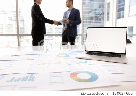 Laptop screen with white mockup, statistical data displaying in papers Laptop screen with white mockup, statistical data displaying in papers 138024696