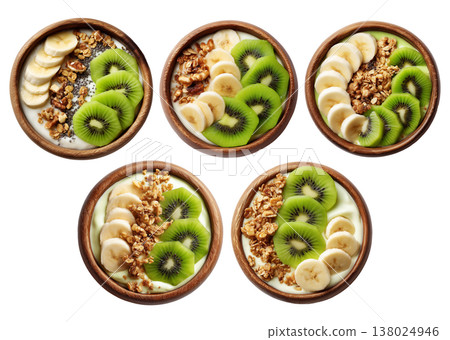 Wooden bowl filled with yogurt or smoothie, sliced kiwi, banana, granola, chia seeds, and fresh mint leaves Wooden bowl filled with yogurt or smoothie, sliced kiwi, banana, granola, chia seeds, and fresh mint leaves 138024946