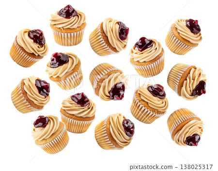 Multiple cupcakes with caramel frosting and cherry topping scattered on white background, sweet dessert pattern concept Multiple cupcakes with caramel frosting and cherry topping scattered on white background, sweet dessert pattern concept 138025317