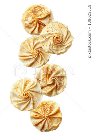 Folded pancakes arranged in elegant rosette swirls, view from above, isolated on white background. Concept of breakfast food art 138025319