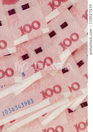 red Chinese money in denominations of one hundred yuan, heap of paper Chinese banknotes in denominations of 100 yuan red Chinese money in denominations of one hundred yuan, heap of paper Chinese banknotes in denominations of 100 yuan 138025834