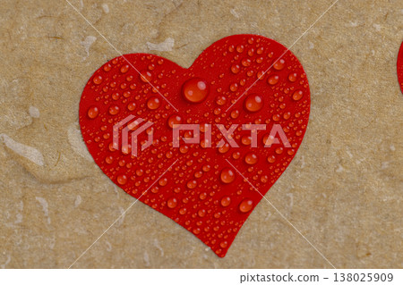 a piece of corrugated cardboard with red hearts covered with water droplets a piece of corrugated cardboard with red hearts covered with water droplets 138025909