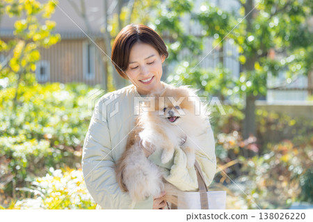 Lifestyle: A woman holding her pet dog 138026220