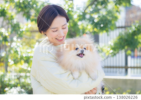 Lifestyle: A woman holding her pet dog Lifestyle: A woman holding her pet dog 138026226