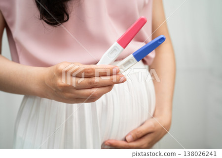 Asian holding pregnancy test for female of ovulation day, fetus, maternity, childbirth, birth control. Asian holding pregnancy test for female of ovulation day, fetus, maternity, childbirth, birth control. 138026241