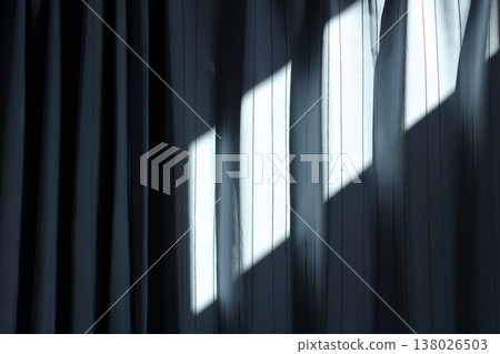 The sunlight coming through the window is projected onto the curtains. 138026503