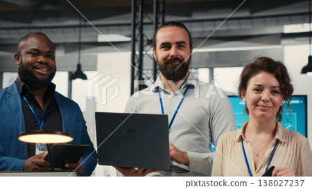 Portrait of diverse business associates analyzing data insights meeting in office, consulting the analysis forecast before developing a new strategy for the enterprise activity. Camera B. 138027237