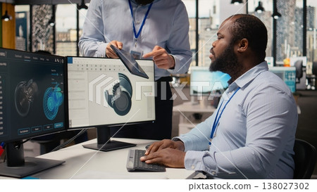 Manager overseeing engineer using CAD app to optimize wind turbine design, reducing carbon footprint. RD office team leader and worker testing advanced materials for eco friendly windmill parts 138027302