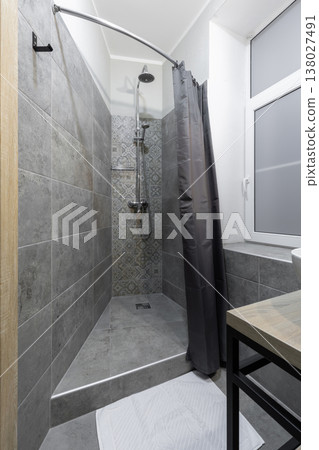 Modern Compact Shower Area in Hostel Bathroom with Grey Tiles Modern Compact Shower Area in Hostel Bathroom with Grey Tiles 138027491