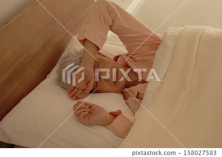 Sleeping senior woman having nightmares in the bedroom Sleeping senior woman having nightmares in the bedroom 138027583