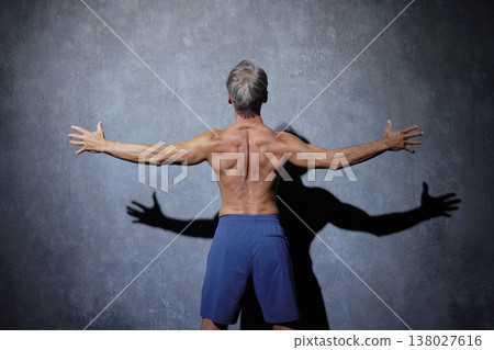 Muscular senior man posing, back view Muscular senior man posing, back view 138027616