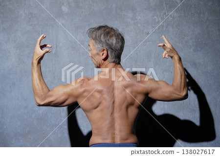 Muscular senior man posing, back view Muscular senior man posing, back view 138027617